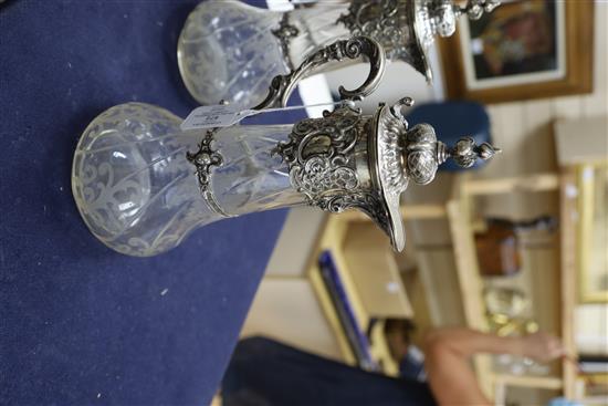 A pair of 19th century German 800 white metal mounted glass claret jugs,